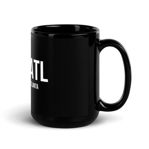 May include: Black ceramic mug with a white graphic that says "ATL" and "Atlanta" underneath. The mug has a large handle.
