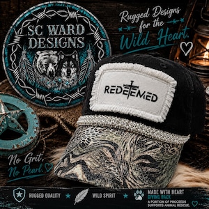 May include: A black baseball cap featuring a frayed white rectangular patch with the word REDEEMED and a cross symbol. The cap has a row of small white pearls along the base of the crown and a camouflage pattern on the brim.