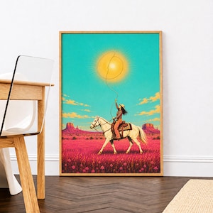 May include: A framed art print featuring a person riding a white horse through a pink desert landscape with red rock formations. The rider holds a rope connected to a glowing yellow sun in a bright turquoise sky, creating a surreal desert scene.