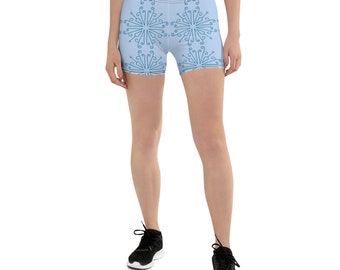 May include: Light blue athletic shorts with a repeating pattern of stylized snowflakes. The shorts are made of a stretchy, comfortable fabric.
