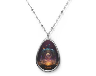 May include: A silver chain necklace with a teardrop-shaped pendant featuring a glowing orange and yellow pumpkin with leaves inside. The pendant has a black border and the word "Autumn" is printed below it.