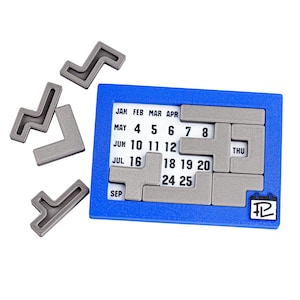Op de afbeelding: Een blauwe kalenderpuzzel met grijze puzzelstukken. De kalenderpuzzel heeft de maanden januari, februari, maart, april, mei, juni, juli, september en de dagen van de week donderdag. De puzzelstukken zijn L-vormig en T-vormig.