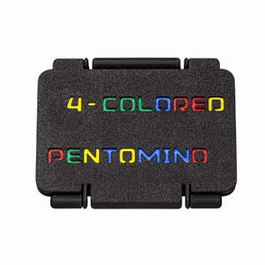 May include: Black rectangular game case with the words "4-COLORED PENTOMINO" in yellow, green, blue, and red. The case has a textured surface and a hinged lid. The game is likely a puzzle or strategy game.