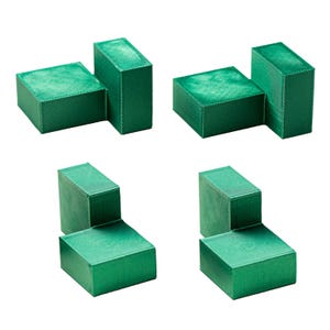 May include: Four green wooden blocks, each with a different shape, are arranged in a grid pattern. The blocks are made of a smooth, textured wood and have a light green color.