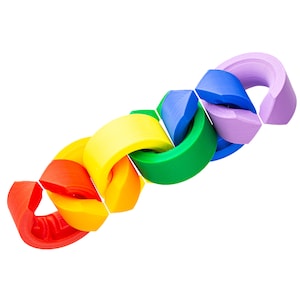 May include: A rainbow-colored chain of interlocking plastic rings. The rings are connected in a continuous loop, creating a colorful and playful design.