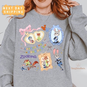 A gray sweatshirt with various cartoon animal characters and a "Zootopia" logo printed on it.