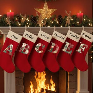 May include: Six red Christmas stockings with white cuffs, each featuring a unique patchwork-style letter from A to F and a personalized name: Ava, Bella, Chloe, Daniel, Emily, and Fiona. The stockings are hung in a row against a fireplace mantel.