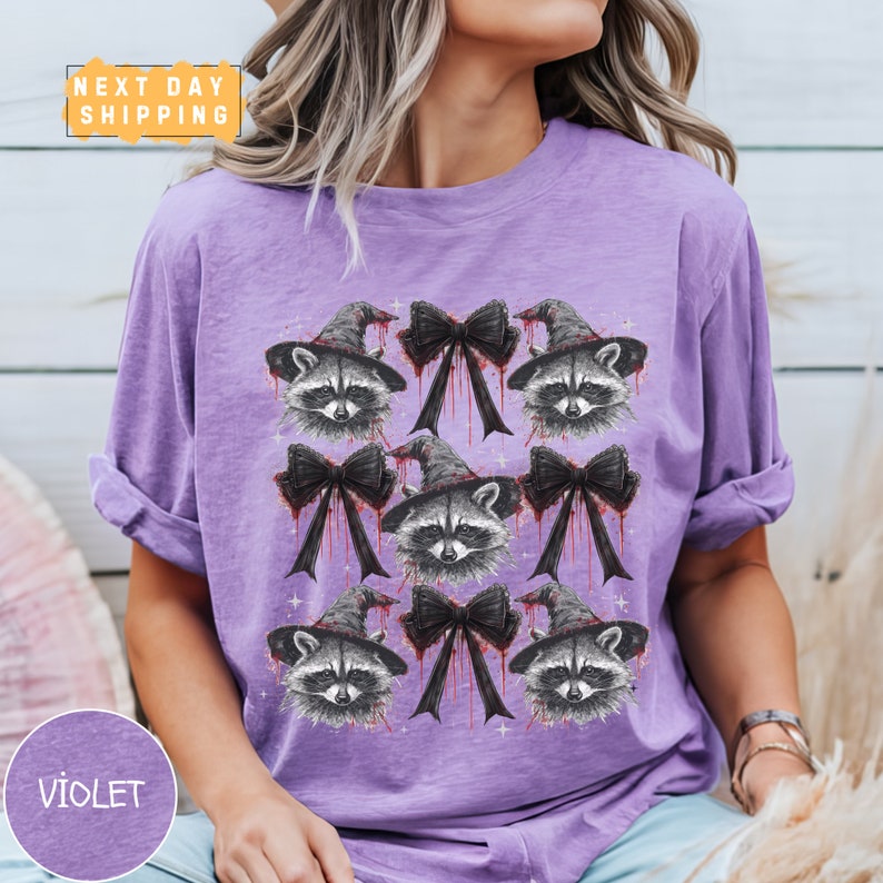 a woman wearing a purple shirt with raccoons on it