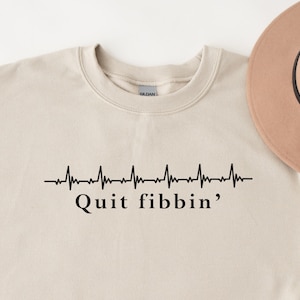 a sweatshirt with a hat on top of it