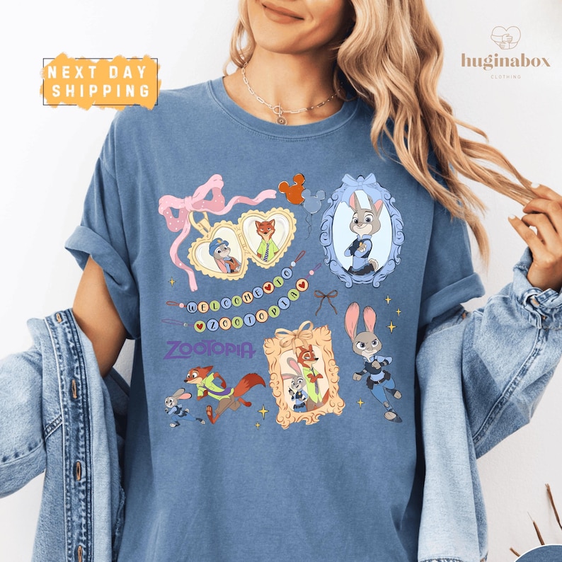 A woman wearing a blue t-shirt with various cartoon animal characters and a heart-shaped ribbon design.