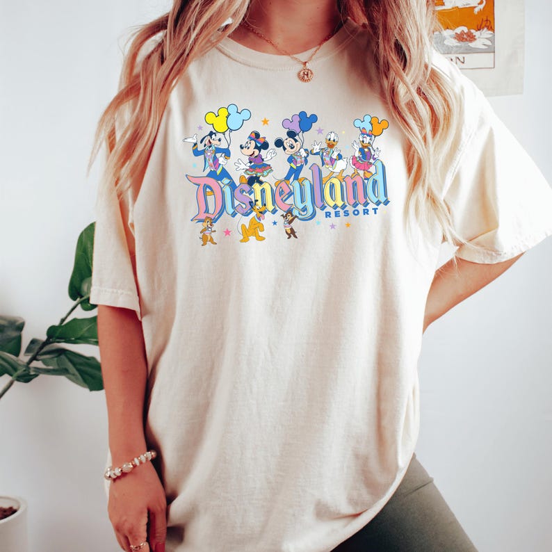 a woman wearing a disney world shirt