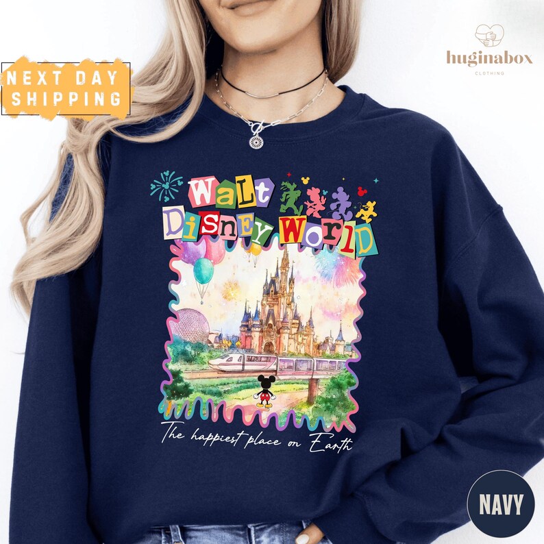 A woman wearing a navy blue sweatshirt with a colorful graphic of Walt Disney World and the text "The happiest place on Earth" printed on it.