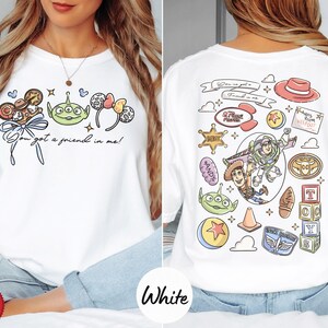 The image is a collage of two pictures, one showing the front of a white t-shirt with a cartoon character and text, and the other showing the back of the same t-shirt with various cartoon characters and text.