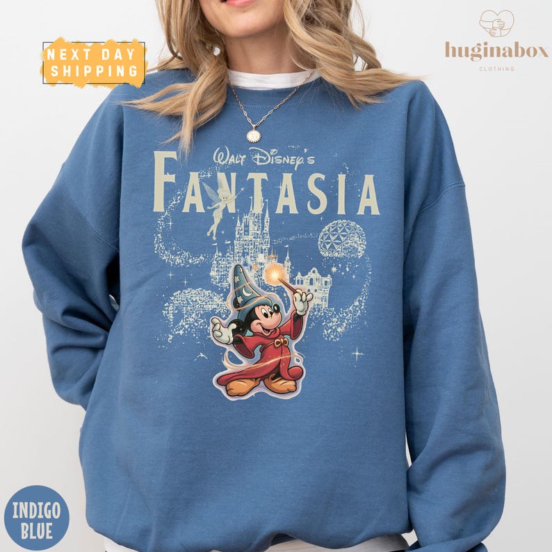 A woman wearing a blue sweatshirt with a Disney-themed graphic of Mickey Mouse and the text "Disney's Fantaasia" printed on it.