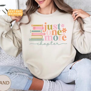 a woman sitting on a couch holding a donut