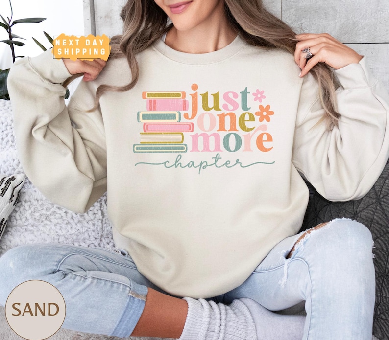 a woman sitting on a couch holding a donut