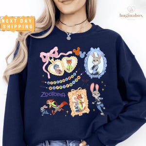 A woman wearing a navy blue sweatshirt with various cartoon animal characters and designs printed on it.
