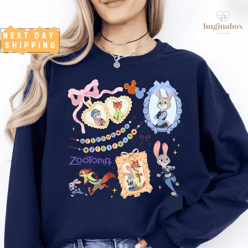 A woman wearing a navy blue sweatshirt with various cartoon animal characters and designs printed on it.