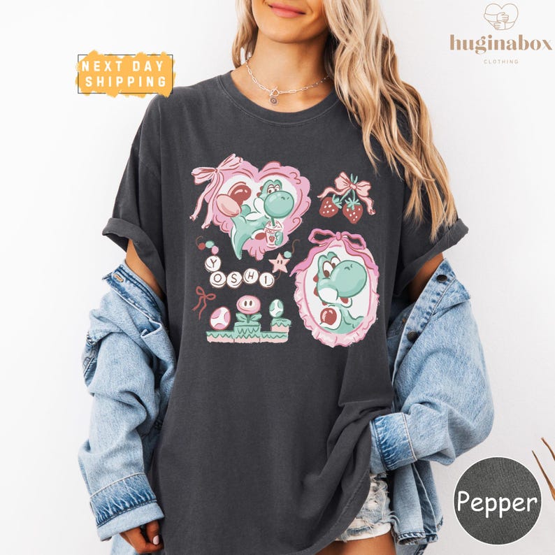 A woman wearing a black t-shirt with a graphic design featuring a character from the Mario video game franchise.
