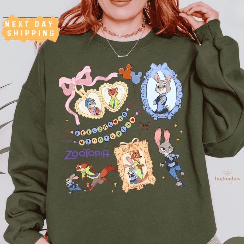 A person wearing a green sweatshirt with various cartoon animal characters and a "Zootopia" theme printed on it.