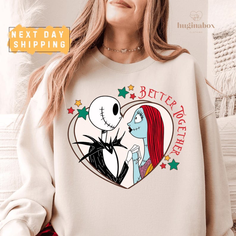 A woman wearing a white sweatshirt with a graphic design featuring a skeleton and a woman's face, along with the text "Better together".