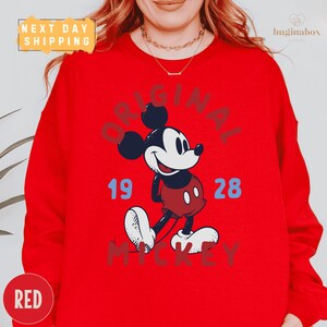 A red sweatshirt with a graphic of Mickey Mouse printed on it.