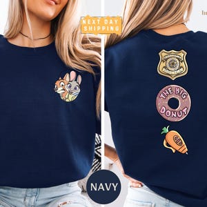 The image is a collage of two photos of a woman wearing a navy blue t-shirt with various cartoon and police-themed designs.
