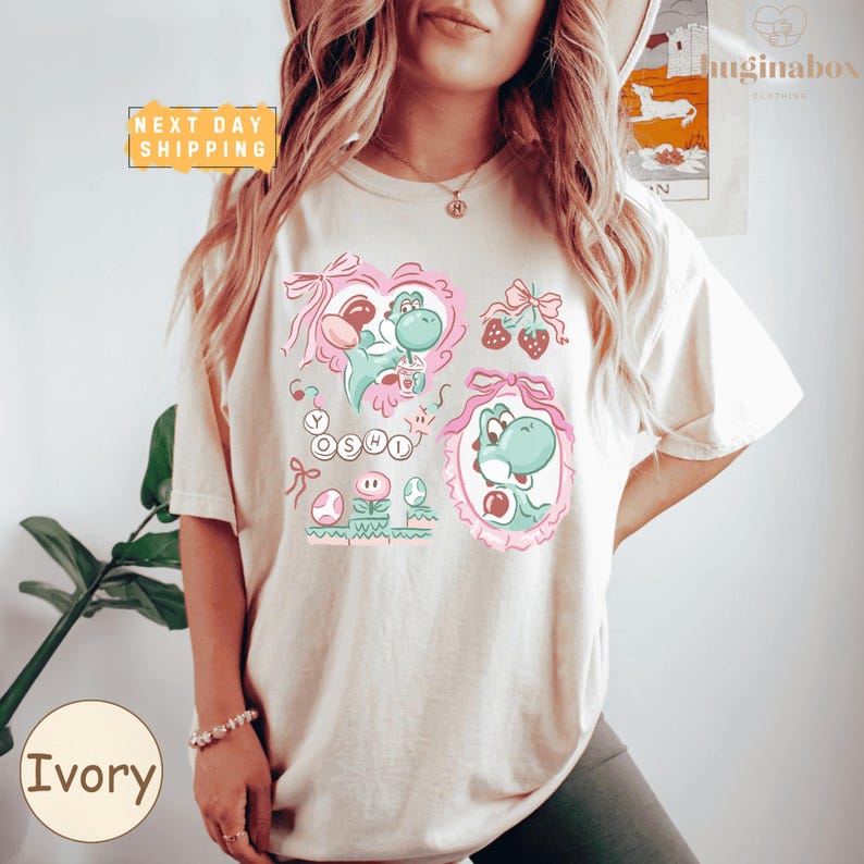 A woman wearing a white t-shirt with a colorful graphic design featuring a character from the Mario video game franchise.