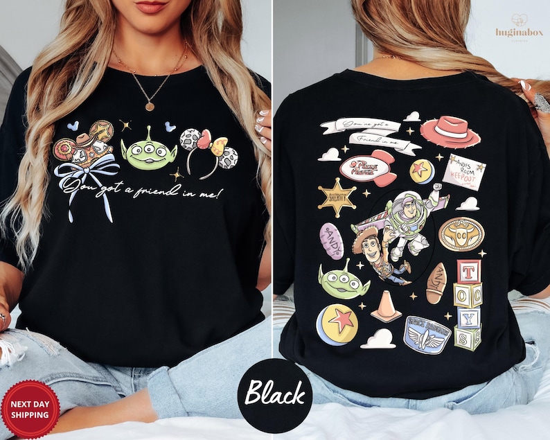 a woman wearing a black t-shirt with various cartoon characters and designs printed on it.