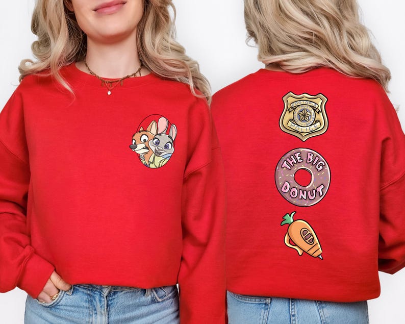 A woman wearing a red sweatshirt with cartoon characters and text on the back.