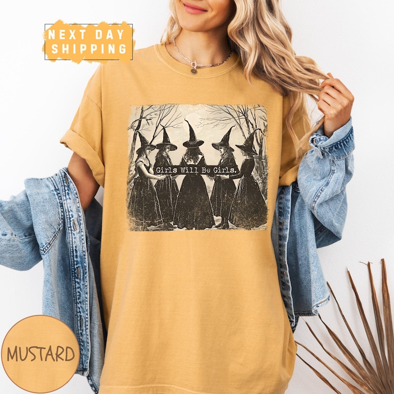 a woman wearing a t - shirt with a picture of witches on it