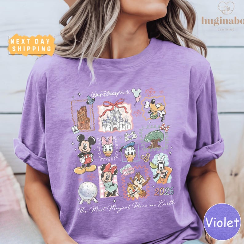 A person wearing a purple t-shirt with various Disney characters and logos printed on it.
