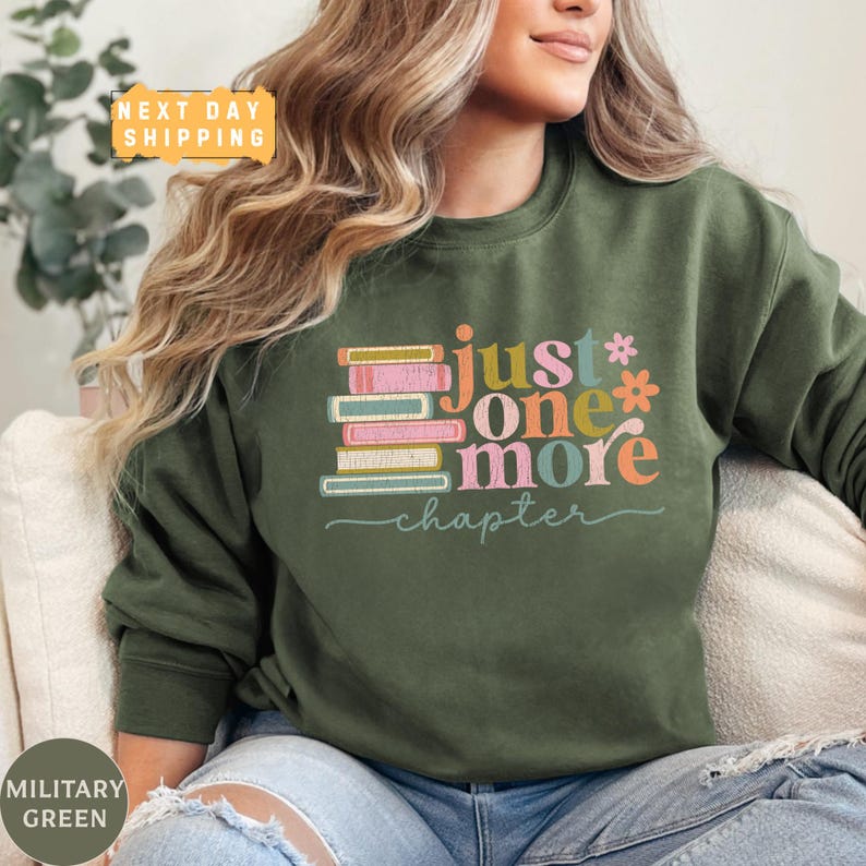 a woman sitting on a couch wearing a green sweatshirt