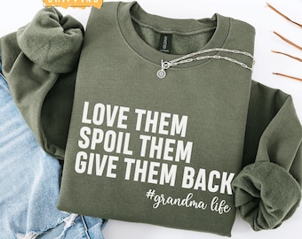May include: A green sweatshirt with the text "Love them, spoil them, give them back #grandma life" printed in white.