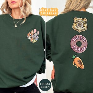 The image is a collage of two photos of a woman wearing a green sweatshirt with various cartoon characters and designs on the back.
