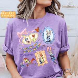 A woman wearing a purple t-shirt with various cartoon animal characters and a decorative frame.