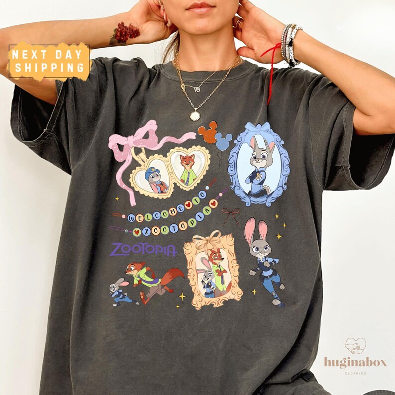 A person wearing a black t-shirt with various cartoon animal characters and a heart-shaped ribbon design.