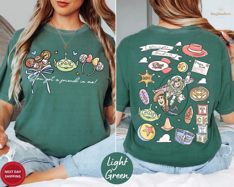 A woman wearing a green t-shirt with various cartoon characters and icons printed on it, including a character from the Toy Story franchise.
