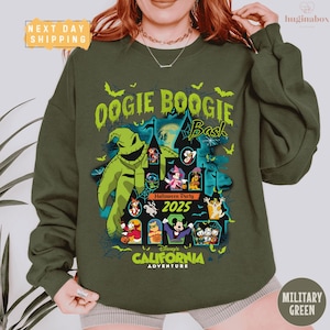 May include: Military green sweatshirt with a graphic promoting the Oogie Boogie Bash Halloween Party at Disney's California Adventure in 2025. The design features Oogie Boogie and other Disney characters.