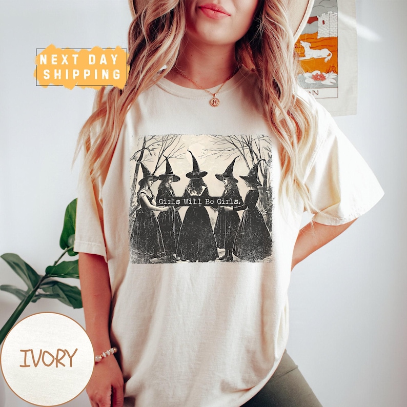 a woman wearing a t - shirt with a picture of witches on it