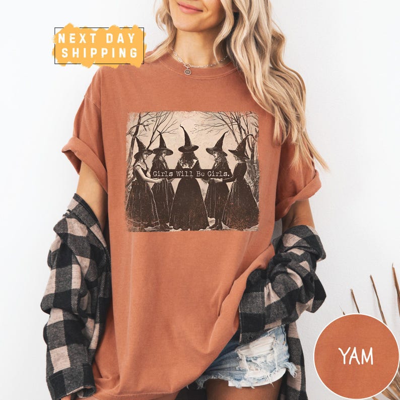 a woman wearing a brown shirt with witches on it