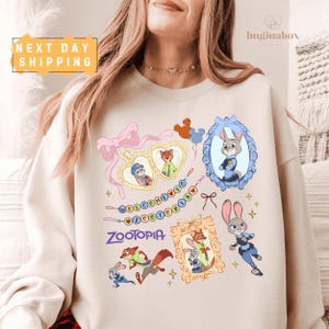 A woman wearing a white sweatshirt with various cartoon animal characters and a heart-shaped frame.