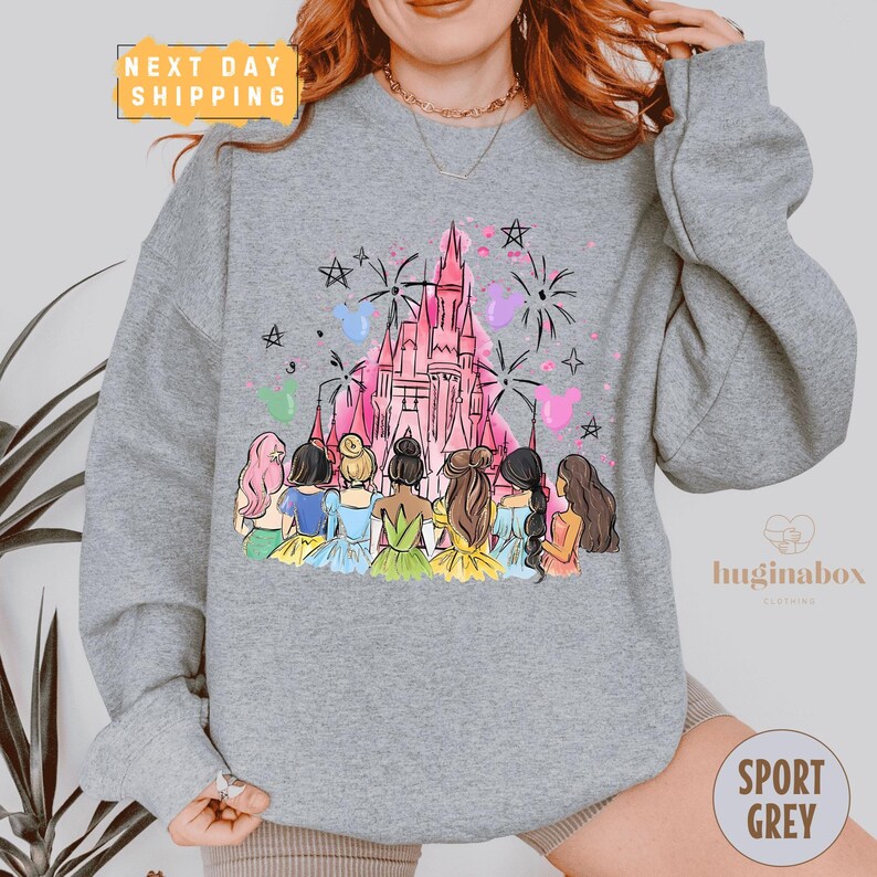 A gray sweatshirt with a colorful illustration of a castle and a group of women in various outfits.