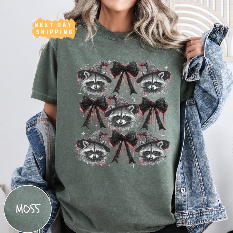 a woman wearing a green shirt with raccoons on it
