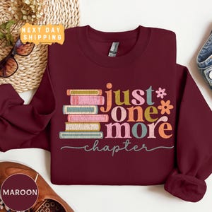 a maroon sweatshirt with the words just one more on it