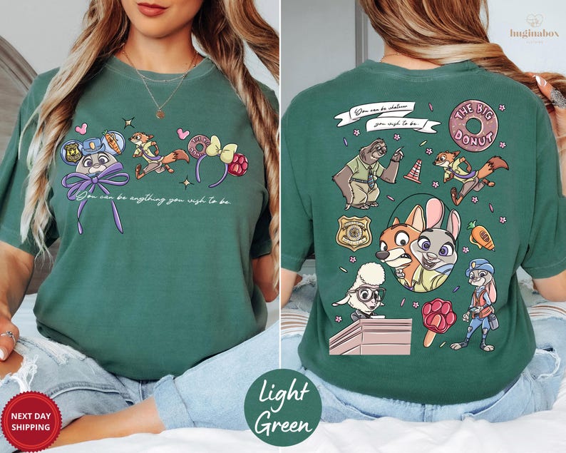 A woman wearing a green t-shirt with a cartoon character design on the front and the back.