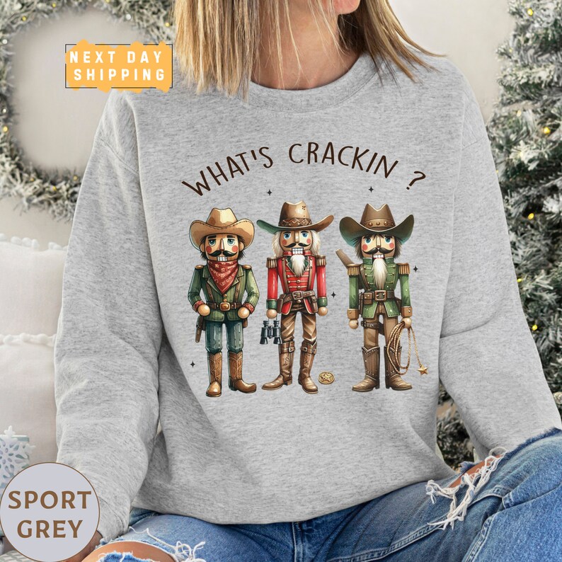 a woman wearing a sweatshirt that says what's crackin?