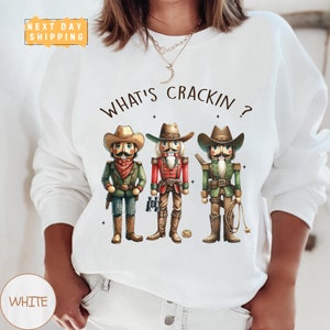 a woman wearing a white shirt with three cartoon characters on it