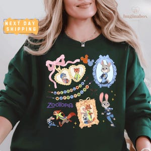 A woman wearing a green sweatshirt with various cartoon animal characters and a message printed on it.