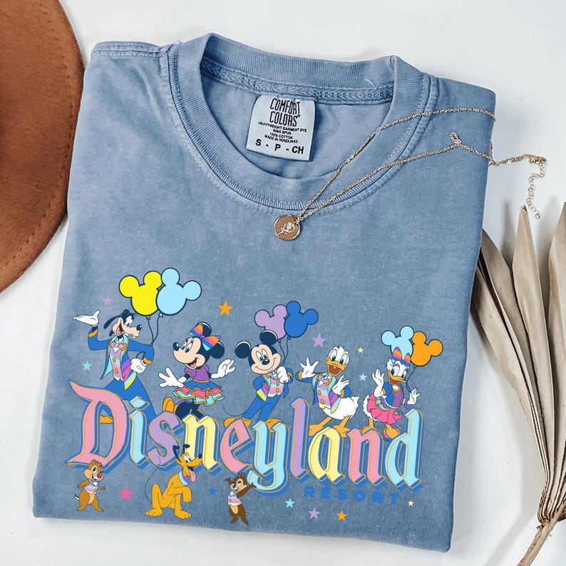 a blue shirt with a mickey mouse design on it